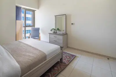a bedroom with a bed and a mirror and a dresser at Frank Porter - Churchill Residence Tower 2 in Dubai