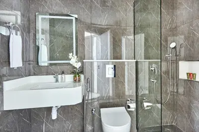 a bathroom with a sink and a toilet and a shower at Frank Porter - Samana Park Views in Dubai