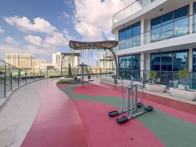 a large building with a pink and green carpet at Frank Porter - Samana Park Views in Dubai