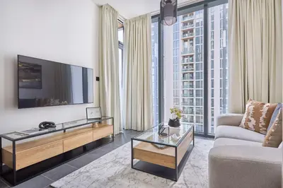 a living room with a tv and a couch at Frank Porter - Sobha Hartland The Crest Tower C in Dubai
