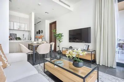 a living room with a couch and a table at Frank Porter - Sobha Hartland The Crest Tower C in Dubai