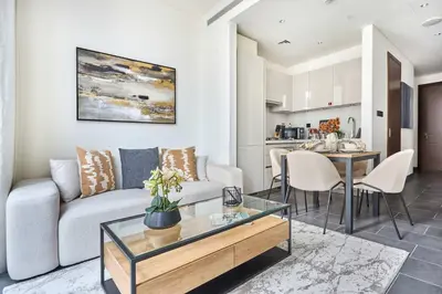 a living room with a couch and a table at Frank Porter - Sobha Hartland The Crest Tower C in Dubai