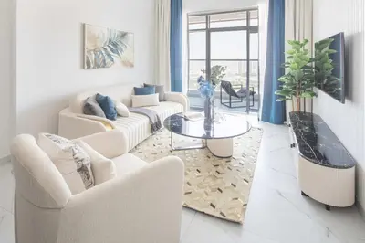 a living room with two couches and a table at Frank Porter - Opalz By Danube - Tower 2 in Dubai