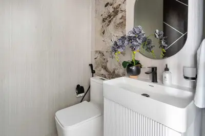 a bathroom with a toilet and a sink and a mirror at Frank Porter - Opalz By Danube - Tower 2 in Dubai