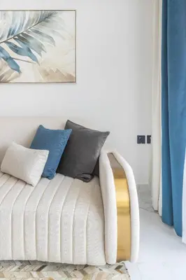 a living room with a couch with pillows on it at Frank Porter - Opalz By Danube - Tower 2 in Dubai