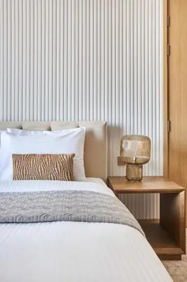 a bedroom with a bed and a table with a lamp at Frank Porter - Vida Dubai Mall Tower 2 in Dubai