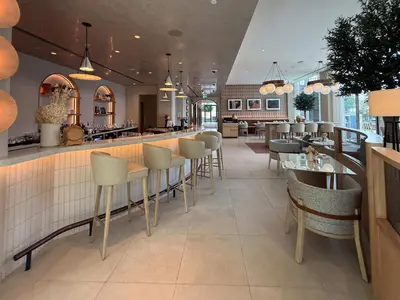 a restaurant with a bar and tables and chairs at Frank Porter - Vida Dubai Mall Tower 2 in Dubai