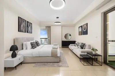 a white bedroom with a bed and a couch at Rimal 5, JBR - 3 Bedroom with Maid's Room Apartment - Allsopp & Allsopp in Dubai