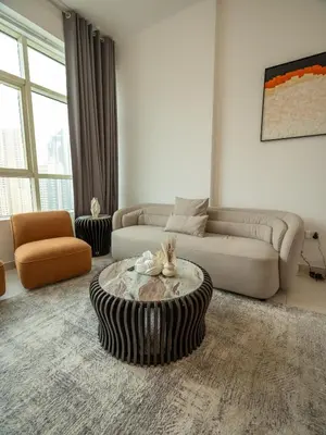 a living room with a couch and a coffee table at Stunning 2bd marina views prime location high floor in Dubai