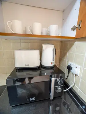 two white coffee makers sitting on top of a microwave at Stunning 2bd marina views prime location high floor in Dubai