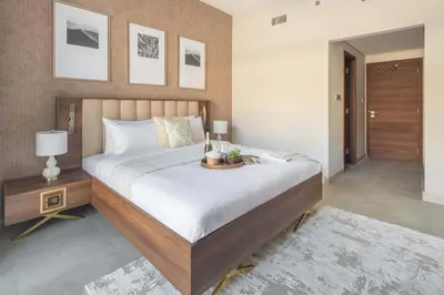 a bedroom with a large bed with a table on it at Frank Porter - Eleganz 5 By Danube in Dubai