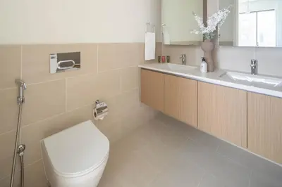 a bathroom with a toilet and a sink at Frank Porter - Rosewater at Creek Beach 3 in Dubai