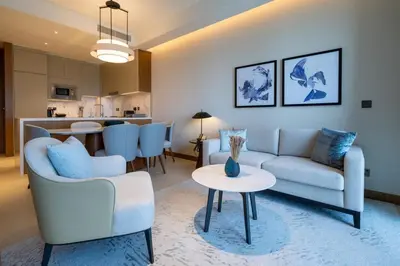 a living room with a couch and a table at Luxury 2BR at Address Opera with Burj Khalifa view in Dubai