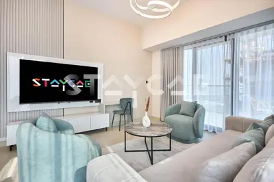 a living room with a couch and a tv at Staycae Holiday Homes Golf Gate - Damac Hills in Dubai