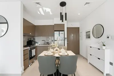 a kitchen with a table and chairs in a room at Steps from Dubai Mall and Burj Khalifa, with Seamless Metro Access to Dubai Marina and Palm Jumeirah - Act One Act Two Tower 1, Downtown Dubai by Deluxe Holiday Homes in Dubai
