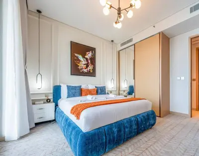 a large bedroom with a large blue bed at New 2 Br Burj View Vida Dubai Mall Direct Access in Dubai