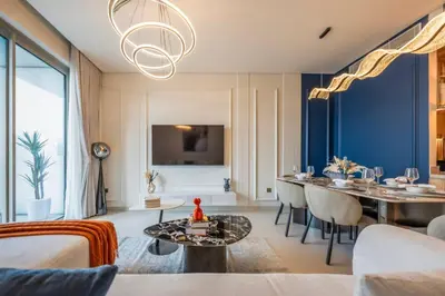 a living room with a table and a dining room at New 2 Br Burj View Vida Dubai Mall Direct Access in Dubai