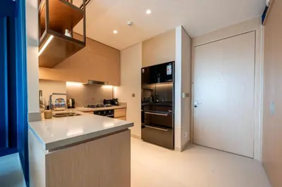 a kitchen with a sink and a stove and a refrigerator at New 2 Br Burj View Vida Dubai Mall Direct Access in Dubai