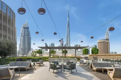 a patio with chairs and tables and buildings at New 2 Br Burj View Vida Dubai Mall Direct Access in Dubai