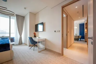 a hotel room with a desk and a mirror at New 2 Br Burj View Vida Dubai Mall Direct Access in Dubai