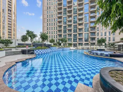 a large swimming pool in a city with tall buildings at Stylish Stay 2 Bedroom Minutes from Burj Khalifa in Dubai