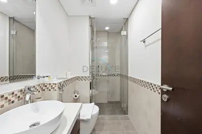 a bathroom with a toilet sink and a shower at Located Near Dubai Mall, Burj Khalifa and Dubai Canal, with Easy Access to Dubai Metro - Vera Tower, Business Bay by Deluxe Holiday Homes in Dubai