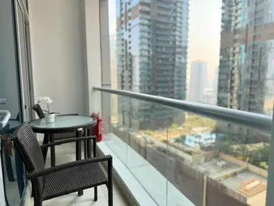 a balcony with a table and chairs and a large window at Marina Luxury 2 Bedroom Boutique Apartment in Dubai