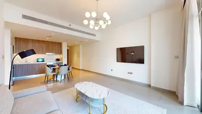 a living room with a couch and a table at Vacationer l Infinity Pool, Beach Access l 1 Bed in Beach Vista in Dubai