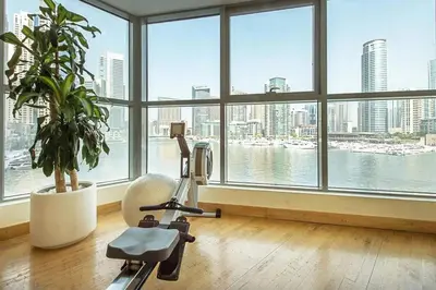 a room with a gym with a large window at Vacationer l 1 Bedroom Stunning Marina Skyline l Free Pool, Gym Access in Dubai