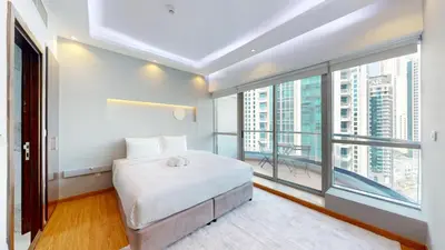 a bedroom with a bed and a large window at Vacationer l 1 Bedroom Stunning Marina Skyline l Free Pool, Gym Access in Dubai