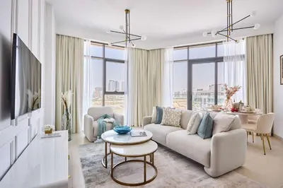 a living room with a couch and a table at Frank Porter - Azizi Park Avenue in Dubai