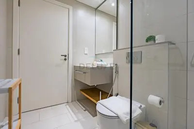 a white bathroom with a toilet and a sink at Beachfront Stay with Full Sea Views, Walking Distance to The Walk, JBR Beach, and Dubai Marina - La Vie, Jumeirah Beach Residence by Deluxe Holiday Homes in Dubai