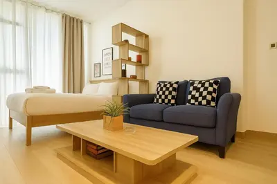 a living room with a couch and a table at Elegant Studio in JVC in Dubai