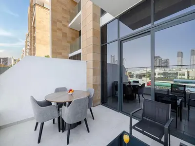 a balcony with a table and chairs on a building at Livin' Holidays - Studio - Riviera Elegance in Dubai