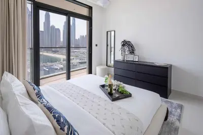 a bedroom with a bed and a large window at Frank Porter - Marina Vista Tower 1 in Dubai