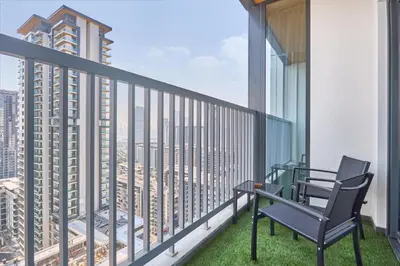 a balcony with a table and chair on a building at STAY BY LATINEM Luxury 1BR plus study Holiday Home CC 2408 in Dubai