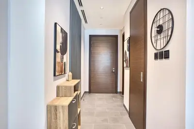 a hallway of a house with a wooden door at STAY BY LATINEM Luxury 1BR plus study Holiday Home CC 2408 in Dubai