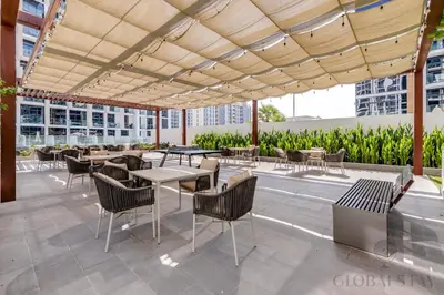 a patio with tables and chairs on a building at GlobalStay 1 Bedroom Apartment for 4 Guests Azizi Riviera 42 Dubai in Dubai