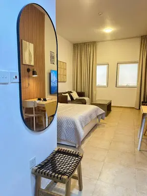a hotel room with a bed and a mirror at Cozy & Stylish Studio in Silicon Oasis in Dubai