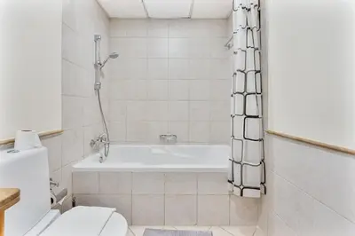 a bathroom with a bath tub and a toilet at Splendid Studio near Canal & famous Golf Clubs in Dubai