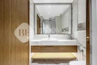 a bathroom with a sink and a mirror at Bloomfields Lumière Stu Azizi Riviera in Dubai