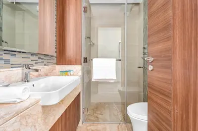 a bathroom with a sink and a toilet and a shower at GuestReady - High-Floor 2BR | City and Canal View in Dubai