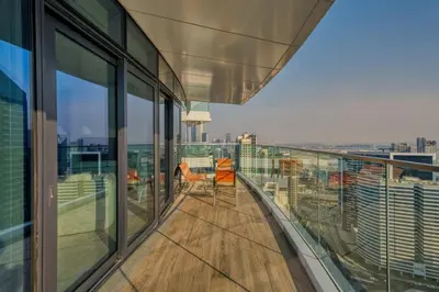 a balcony of a building with a view of the city at GuestReady - High-Floor 2BR | Canal and City View in Dubai
