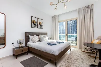 a bedroom with a bed and a desk and a table at 2b Stylish apart in JBR, near Beach&Marina Walk in Dubai