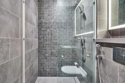 a bathroom with a shower with a glass door at STAY BY LATINEM Luxury 1BR Holiday Home CC 3313 Near Burj Khalifa in Dubai