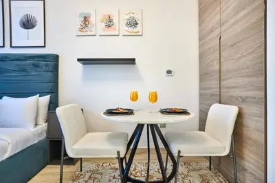 a room with a table and chairs and a bed at Modern Studio in Studio One Tower, Dubai Marina in Dubai