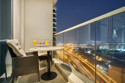 a table and chairs on a balcony with a view of a city at Modern Studio in Studio One Tower, Dubai Marina in Dubai