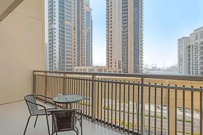 a balcony with a table and chairs and buildings at VayK - Spacious 2BR in Dubai Creek Harbour in Dubai