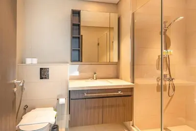 a bathroom with a shower and a sink and a toilet at Central 2BR Downtown Views EB in Dubai