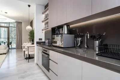 a kitchen with a counter top with a microwave at Peninsula Five Luxurious Business Bay Studio in Dubai